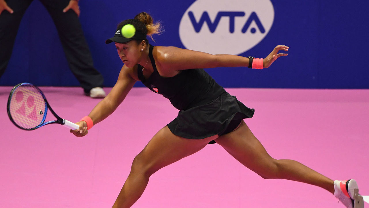 Naomi Osaka of Japan hits a return against Camila Giorgi of Italy during their women's singles semi-final tennis match at the Pan Pacific Open tennis tournament in Tokyo on September 22, 2018.