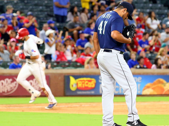 ARLINGTON, TX - SEPTEMBER 21: James Pazos #47 of the Seattle Mariners stands on the mound as Joey Gallo #13 of the Texas Rangers runs the bases after a solo home run in the sixth inning at Globe Life Park in Arlington on September 21, 2018 in Arlington, Texas.