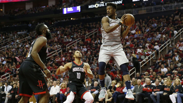 HOUSTON, TX - APRIL 15: Jimmy Butler #23 of the Minnesota Timberwolves looks to pass under the basket against Eric Gordon #10 and James Harden #13 of the Houston Rockets in the second half during Game One of the first round of the 2018 NBA Playoffs at Toyota Center on April 15, 2018 in Houston, Texas.