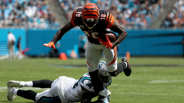 CHARLOTTE, NC - SEPTEMBER 23: A.J. Green #18 of the Cincinnati Bengals runs the ball against James Bradberry #24 of the Carolina Panthers in the second quarter during their game at Bank of America Stadium on September 23, 2018 in Charlotte, North Carolina.