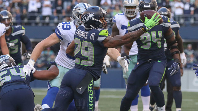 SEATTLE, WA - SEPTEMBER 23: Free safety Earl Thomas #29 of the Seattle Seahawks intercepts a pass against tight end Blake Jarwin #89 of the Dallas Cowboys in the fourth quarter at CenturyLink Field on September 23, 2018 in Seattle, Washington.