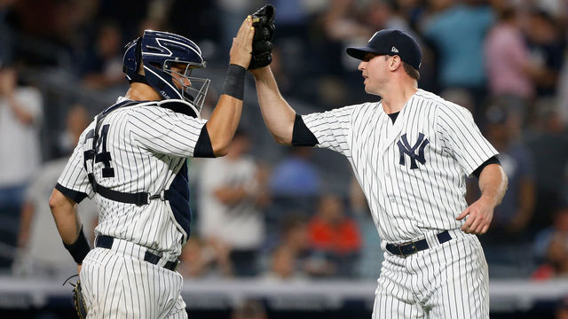NEW YORK, NY - SEPTEMBER 18: Zach Britton #53 and Gary Sanchez #24 of the New York Yankees celebrate after defeating the Boston Red Sox at Yankee Stadium on September 18, 2018 in the Bronx borough of New York City.