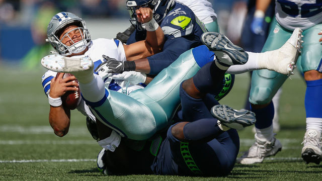 SEATTLE, WA - SEPTEMBER 23: Quarterback Dak Prescott #4 of the Dallas Cowboys is sacked by defensive end Dion Jordan #95 of the Seattle Seahawks at CenturyLink Field on September 23, 2018 in Seattle, Washington.
