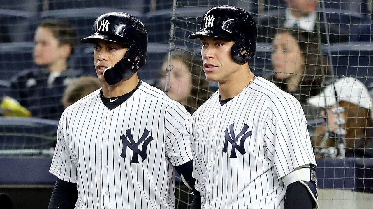 NEW YORK, NY - APRIL 16: Giancarlo Stanton #27 and Aaron Judge #99 of the New York Yankees talk during a pitchig change by the Miami Marlins in the sixth inning at Yankee Stadium on April 16, 2018 in the Bronx borough of New York City.