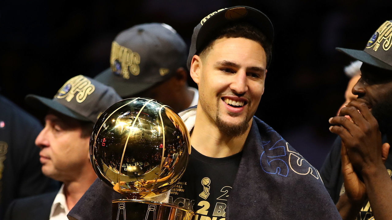 CLEVELAND, OH - JUNE 08: Klay Thompson #11 of the Golden State Warriors celebrates with the Larry O'Brien Trophy after defeating the Cleveland Cavaliers during Game Four of the 2018 NBA Finals at Quicken Loans Arena on June 8, 2018 in Cleveland, Ohio. The Warriors defeated the Cavaliers 108-85 to win the 2018 NBA Finals.