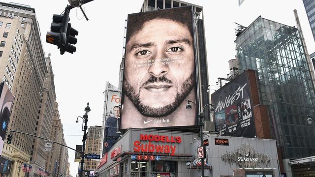 TOPSHOT - A Nike Ad featuring American football quarterback Colin Kaepernick is on diplay September 8, 2018 in New York City. - Nike's new ad campaign featuring Kaepernick, the American football player turned activist against police violence, takes a strong stance on a divisive issue which could score points with millennials but risks alienating conservative customers. The ads prompted immediate calls for Nike boycotts over Kaepernick, who has been castigated by US President Donald Trump and other conservatives over his kneeling protests during the playing of the US national anthem.