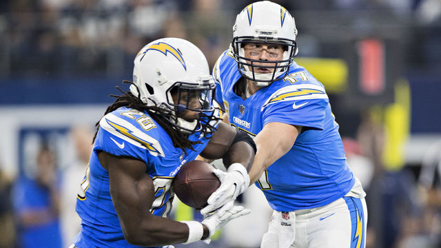 ARLINGTON, TX - NOVEMBER 23: Philip Rivers #17 hands off the ball to Melvin Gordon #28 of the Los Angeles Chargers yells out a play during a game against the Dallas Cowboys at AT&T Stadium on November 23, 2017 in Arlington, Texas. The Chargers defeated the Cowboys 28-6.