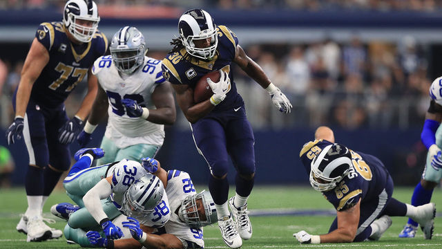 ARLINGTON, TX - OCTOBER 01: Todd Gurley #30 of the Los Angeles Rams runs the ball past Jeff Heath #38 and Brian Price #92 of the Dallas Cowboys in the third quarter at AT&T Stadium on October 1, 2017 in Arlington, Texas.