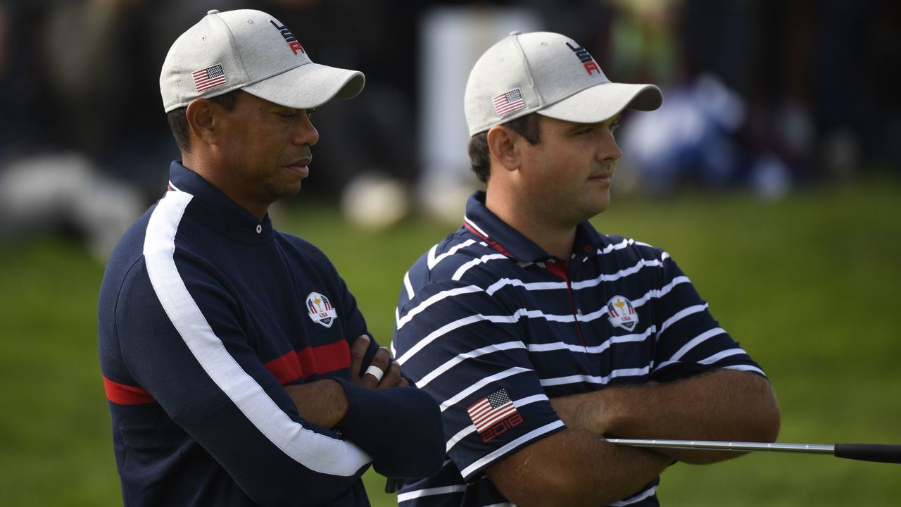 US golfer Tiger Woods (L) and US golfer Patrick Reed look on during their fourball match on the first day of the 42nd Ryder Cup at Le Golf National Course at Saint-Quentin-en-Yvelines, south-west of Paris on September 28, 2018.