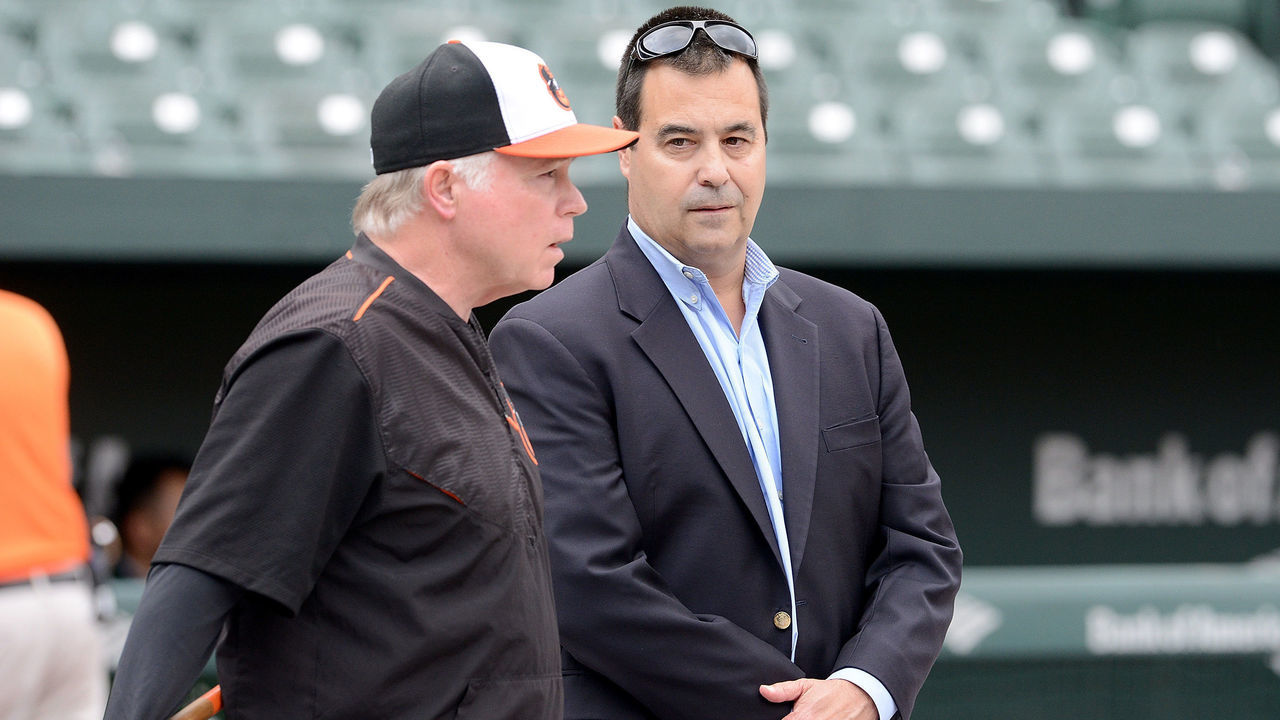 BALTIMORE, MD - SEPTEMBER 13: Manager Buck Showalter #26 of the Baltimore Orioles and general manager Dan Duquette talk during batting practice before the game against the Oakland Athletics at Oriole Park at Camden Yards on September 13, 2018 in Baltimore, Maryland.