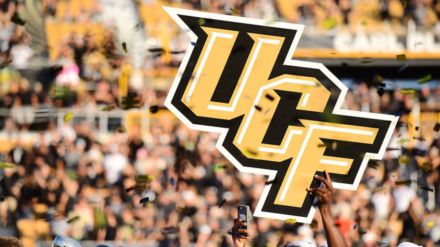 ORLANDO, FL - DECEMBER 2: Members of the UCF Knights football team hoist up the school logo after winning the ACC Championship 62-55 against the Memphis Tigers at Spectrum Stadium on December 2, 2017 in Orlando, Florida.