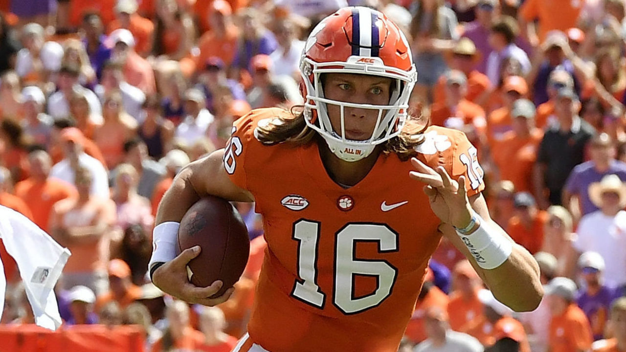 CLEMSON, SC - SEPTEMBER 15: Quarterback Trevor Lawrence #16 runs the football as wide receiver Diondre Overton #14 of the Clemson Tigers blocks cornerback Kindle Vildor #20 of the Georgia Southern Eagles during the football game at Clemson Memorial Stadium on September 15, 2018 in Clemson, South Carolina.