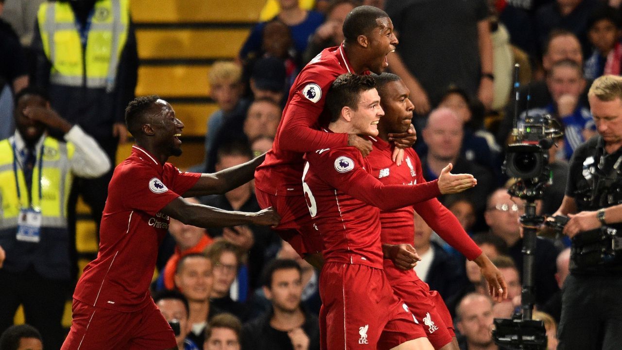 Liverpool's English striker Daniel Sturridge celebrates with teammates after scoring the team's first goal during the English Premier League football match between Chelsea and Liverpool at Stamford Bridge in London on September 29, 2018.
