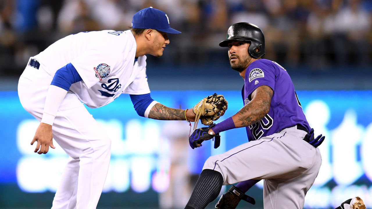 LOS ANGELES, CA - SEPTEMBER 18: Ian Desmond #20 of the Colorado Rockies steals second base in front of Manny Machado #8 of the Los Angeles Dodgers during the fourth inning at Dodger Stadium on September 18, 2018 in Los Angeles, California.