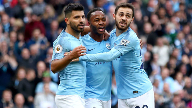 MANCHESTER, ENGLAND - SEPTEMBER 29: Raheem Sterling of Manchester City celebrates scoring the opening goal with Sergio Aguero and Bernardo Silva during the Premier League match between Manchester City and Brighton & Hove Albion at Etihad Stadium on September 29, 2018 in Manchester, United Kingdom.