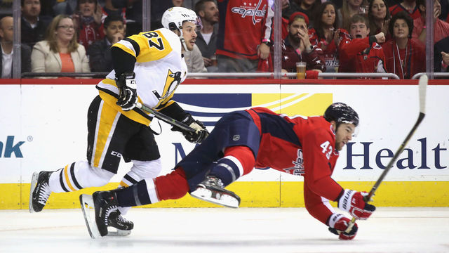 WASHINGTON, DC - APRIL 26: Tom Wilson #43 of the Washington Capitals is checked by Sidney Crosby #87 of the Pittsburgh Penguins during the first period in Game One of the Eastern Conference Second Round during the 2018 NHL Stanley Cup Playoffs at the Capital One Arena on April 26, 2018 in Washington, DC.