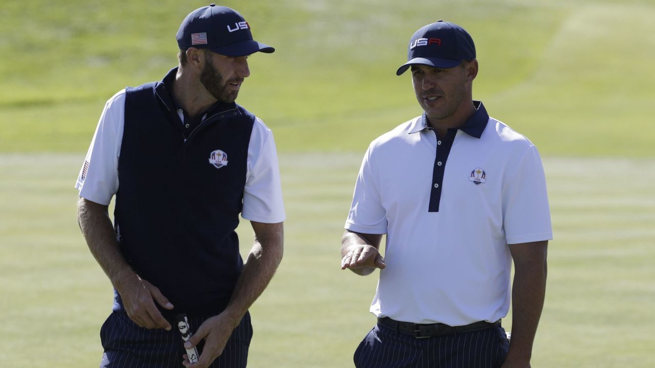 US golfer Dustin Johnson (L) and US golfer Brooks Koepka speak during their foursomes match on the second day of the 42nd Ryder Cup at Le Golf National Course at Saint-Quentin-en-Yvelines, south-west of Paris, on September 29, 2018.