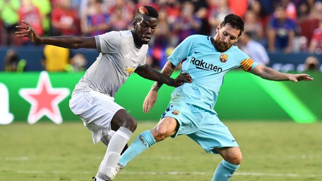 Lionel Messi of Barcelona (R) vies for the ball with Paul Pogba of Manchester United (L) during their International Champions Cup (ICC) football match on July 26, 2017 at FedExField in Landover, Maryland.