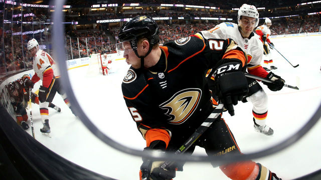 ANAHEIM, CA - DECEMBER 29: Ondrej Kase #25 of the Anaheim Ducks is pressured in the corner by Mikael Backlund #11 of the Calgary Flames during the first period of a game at Honda Center on December 29, 2017 in Anaheim, California.