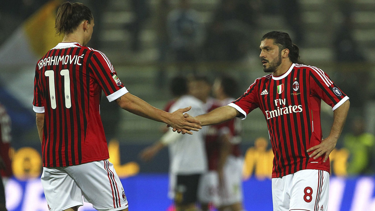 PARMA, ITALY - MARCH 17: Zlatan Ibrahimovic (L) and Gennaro Gattuso (R) of AC Milan celebrate a victory at the end of the Serie A match between Parma FC and AC Milan at Stadio Ennio Tardini on March 17, 2012 in Parma, Italy.