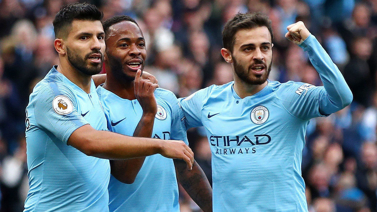MANCHESTER, ENGLAND - SEPTEMBER 29: Raheem Sterling of Manchester City celebrates scoring the opening goal with Sergio Aguero and Bernardo Silva during the Premier League match between Manchester City and Brighton & Hove Albion at Etihad Stadium on September 29, 2018 in Manchester, United Kingdom.