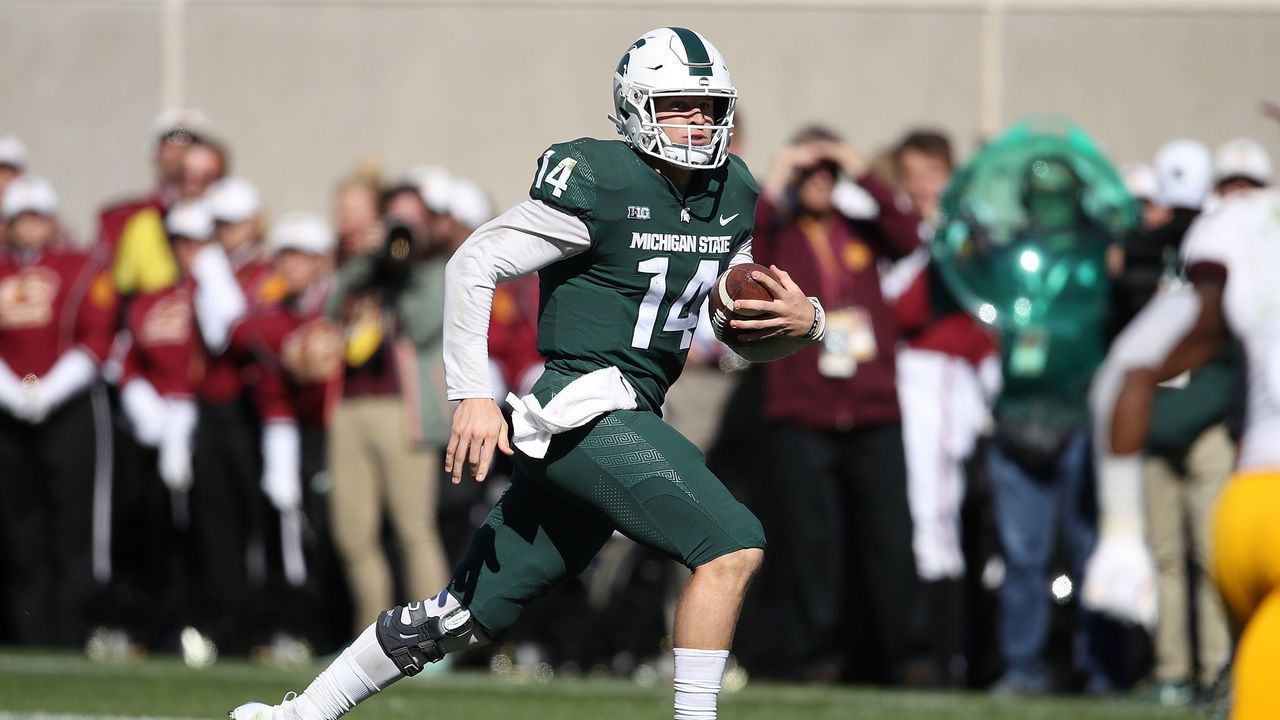 EAST LANSING, MI - SEPTEMBER 29: Brian Lewerke #14 of the Michigan State Spartans runs for a first down in the second half while playing the Central Michigan Chippewas at Spartan Stadium on September 29, 2018 in East Lansing, Michigan.