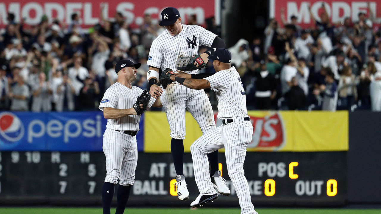 NEW YORK, NEW YORK - OCTOBER 03: Aaron Judge #99 of the New York Yankees celebrates with Brett Gardner #11 and Aaron Hicks #31 after defeating the Oakland Athletics by a score of 7-2 to win the American League Wild Card Game at Yankee Stadium on October 03, 2018 in the Bronx borough of New York City.
