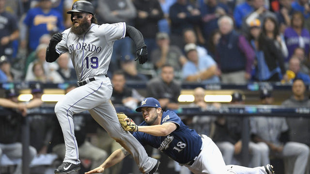 MILWAUKEE, WI - OCTOBER 04: Charlie Blackmon #19 of the Colorado Rockies is tagged out by Mike Moustakas #18 of the Milwaukee Brewers in the ninth inning of Game One of the National League Division Series at Miller Park on October 4, 2018 in Milwaukee, Wisconsin.