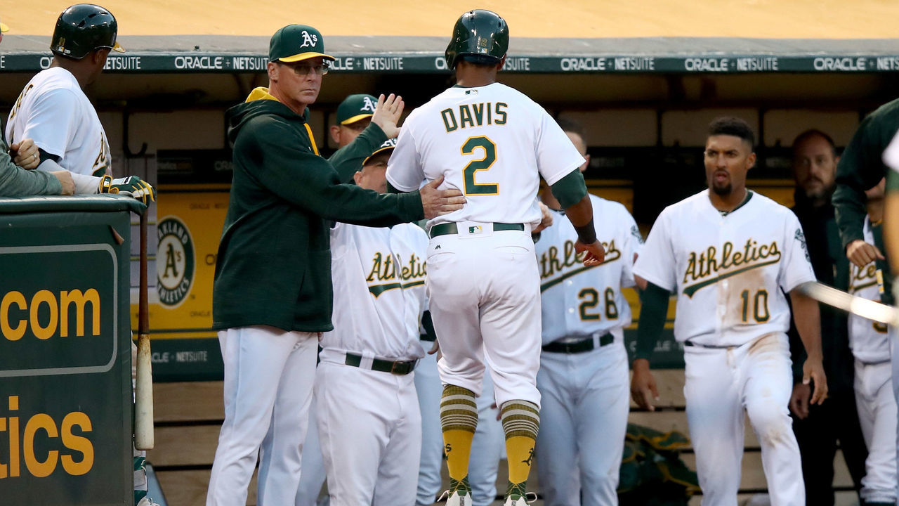 OAKLAND, CA - JULY 18: Khris Davis #2 of the Oakland Athletics is congratulated by manager Bob Melvin after he scored on a wild pitch by Blake Snell #4 of the Tampa Bay Rays in the fourth inning at Oakland Alameda Coliseum on July 18, 2017 in Oakland, California.