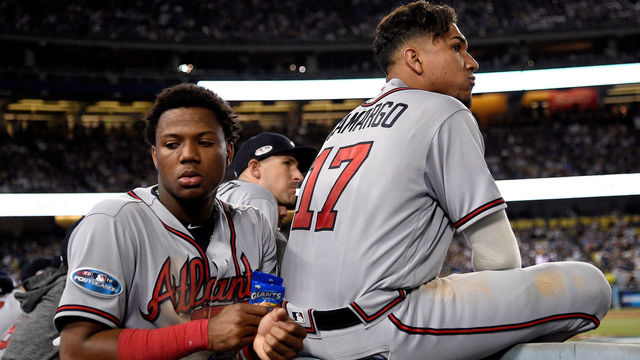 LOS ANGELES, CA - OCTOBER 05: Ronald Acuna Jr. #13 and Johan Camargo #17 of the Atlanta Braves reacts during the eighth inning against the Los Angeles Dodgers during Game Two of the National League Division Series at Dodger Stadium on October 5, 2018 in Los Angeles, California. The Los Angeles Dodgers defeated the Atlanta Braves 3-0.