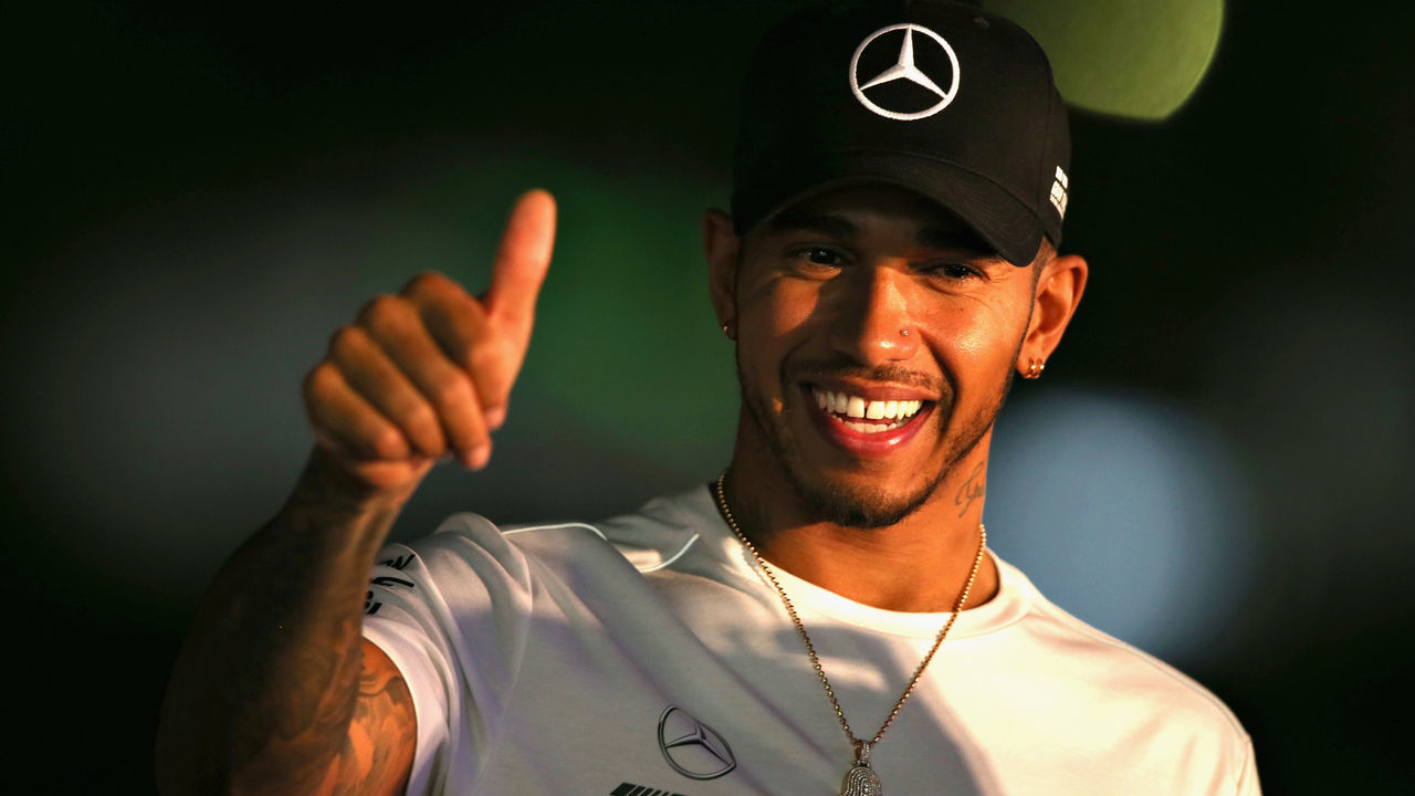 SUZUKA, JAPAN - OCTOBER 06: Lewis Hamilton of Great Britain and Mercedes GP waves to fans on the fan stage after qualifying for the Formula One Grand Prix of Japan at Suzuka Circuit on October 6, 2018 in Suzuka.