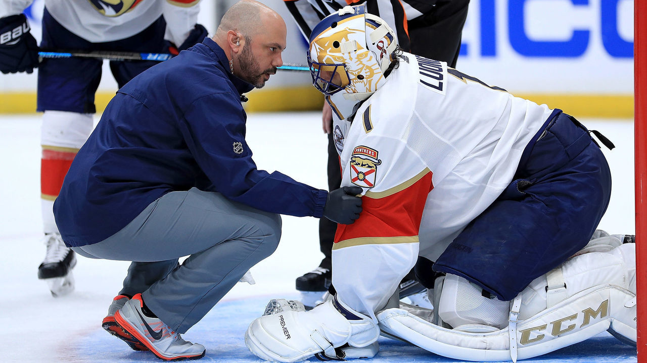 TAMPA, FL - OCTOBER 06: Roberto Luongo #1 of the Florida Panthers is escorted off the ice by trainers during Opening Night against the Tampa Bay Lightning at Amalie Arena on October 6, 2018 in Tampa, Florida.