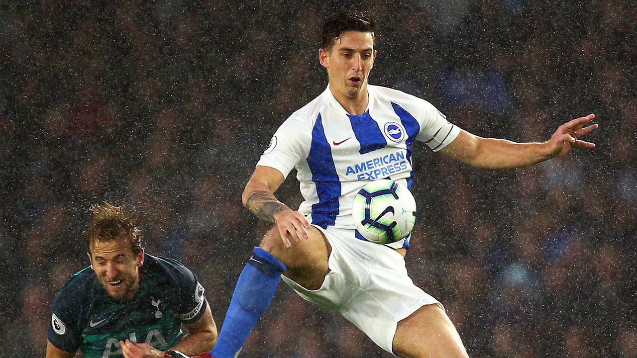 BRIGHTON, ENGLAND - SEPTEMBER 22: Lewis Dunk of Brighton and Hove Albion jumps for the ball under pressure from Harry Kane of Tottenham Hotspur during the Premier League match between Brighton & Hove Albion and Tottenham Hotspur at American Express Community Stadium on September 22, 2018 in Brighton, United Kingdom.