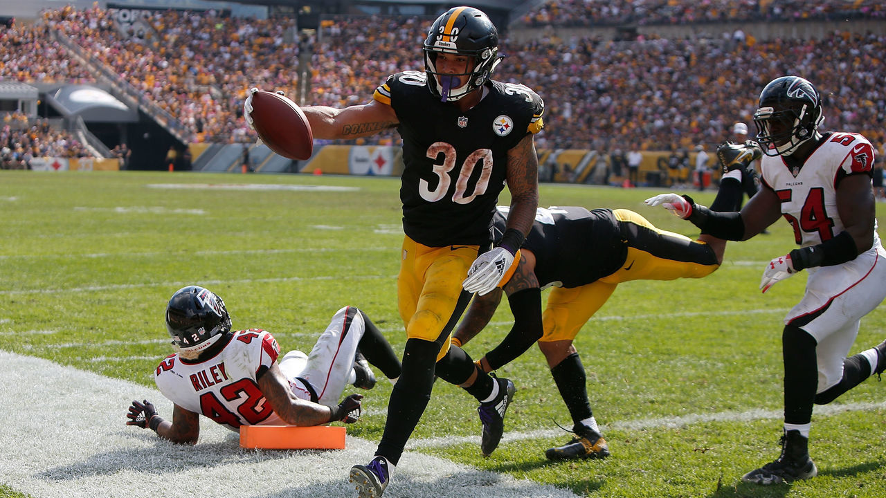 PITTSBURGH, PA - OCTOBER 07: James Conner #30 of the Pittsburgh Steelers runs into the end zone past Duke Riley #42 of the Atlanta Falcons for a 2 yard touchdown in the second half during the game at Heinz Field on October 7, 2018 in Pittsburgh, Pennsylvania.