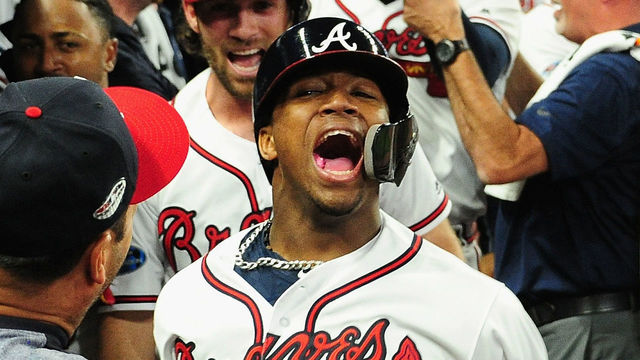 ATLANTA, GA - OCTOBER 07: Ronald Acuna Jr. #13 of the Atlanta Braves celebrates with teammates in the dugout after hitting a grand slam home run in the second inning against the Los Angeles Dodgers during Game Three of the National League Division Series at SunTrust Park on October 7, 2018 in Atlanta, Georgia.