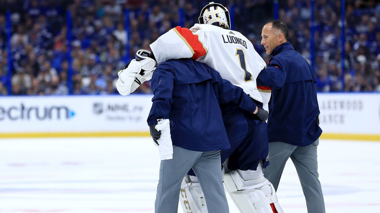 TAMPA, FL - OCTOBER 06: Roberto Luongo #1 of the Florida Panthers is escorted off the ice by trainers during Opening Night against the Tampa Bay Lightning at Amalie Arena on October 6, 2018 in Tampa, Florida.