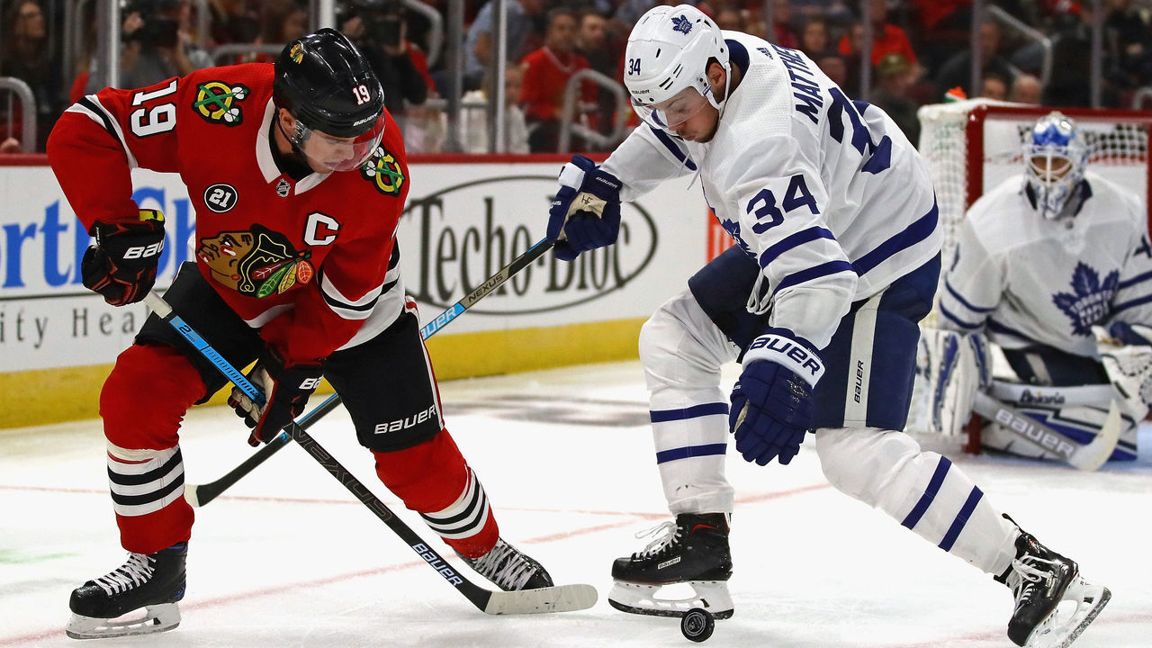CHICAGO, IL - OCTOBER 07: Jonathan Toews #19 of the Chicago Blackhawks and Auston Matthews #34 of the Toronto Maple Leafs battle for the puck during the regular season opening home game at the United Center on October 7, 2018 in Chicago, Illinois. The Maple Leafs defeated the Blackhawks 7-6 in overtime.