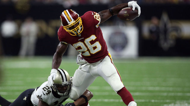 NEW ORLEANS, LA - OCTOBER 08: Adrian Peterson #26 of the Washington Redskins runs with the ball as Vonn Bell #24 of the New Orleans Saints defends during the first half at Mercedes-Benz Superdome on October 8, 2018 in New Orleans, Louisiana.