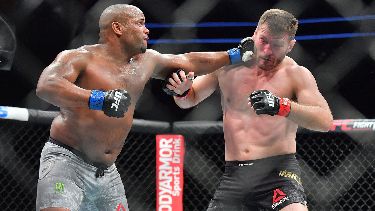 LAS VEGAS, NV - JULY 07: Daniel Cormier (L) lands a punch against Stipe Miocic during their heavyweight championship fight at T-Mobile Arena on July 7, 2018 in Las Vegas, Nevada. Cormier won by first round knockout.