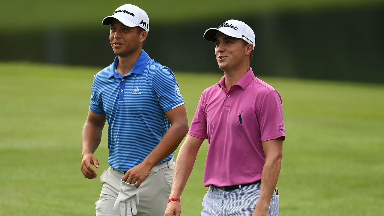 Justin Thomas of the US (R) and Xander Schauffele of the US (L) walk on the 10th fairway during the first round of the 2017 CIMB Classic golf tournament in Kuala Lumpur on October 12, 2017. / AFP PHOTO / MOHD RASFAN
