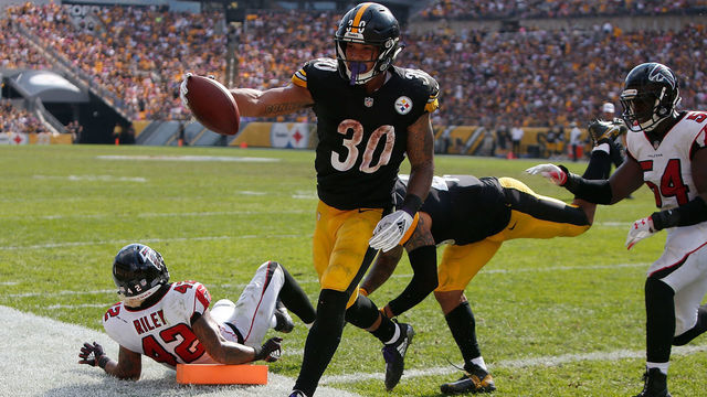 PITTSBURGH, PA - OCTOBER 07: James Conner #30 of the Pittsburgh Steelers runs into the end zone past Duke Riley #42 of the Atlanta Falcons for a 2 yard touchdown in the second half during the game at Heinz Field on October 7, 2018 in Pittsburgh, Pennsylvania.