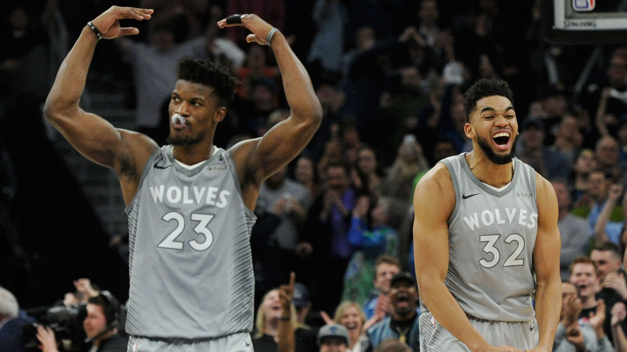 MINNEAPOLIS, MN - APRIL 11: Jimmy Butler #23 and Karl-Anthony Towns #32 of the Minnesota Timberwolves celebrate in the final minute of overtime of the game against the Denver Nuggets on April 11, 2018 at the Target Center in Minneapolis, Minnesota. The Timberwolves defeated the Nuggets 112-106.