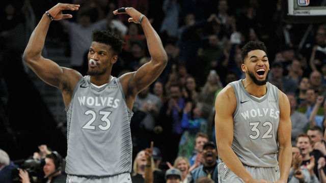 MINNEAPOLIS, MN - APRIL 11: Jimmy Butler #23 and Karl-Anthony Towns #32 of the Minnesota Timberwolves celebrate in the final minute of overtime of the game against the Denver Nuggets on April 11, 2018 at the Target Center in Minneapolis, Minnesota. The Timberwolves defeated the Nuggets 112-106.