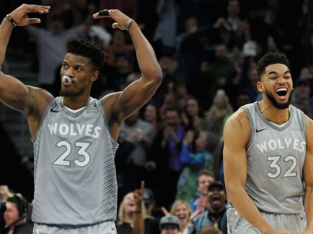 MINNEAPOLIS, MN - APRIL 11: Jimmy Butler #23 and Karl-Anthony Towns #32 of the Minnesota Timberwolves celebrate in the final minute of overtime of the game against the Denver Nuggets on April 11, 2018 at the Target Center in Minneapolis, Minnesota. The Timberwolves defeated the Nuggets 112-106.