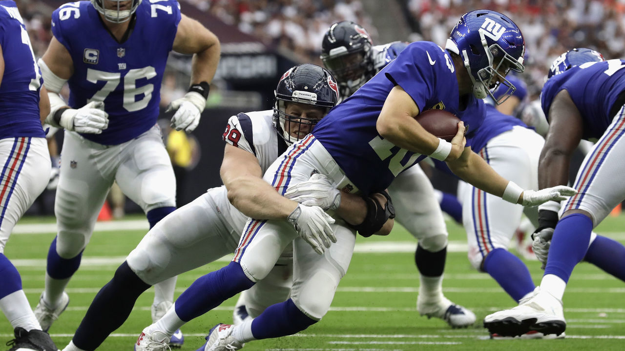 HOUSTON, TX - SEPTEMBER 23: Eli Manning #10 of the New York Giants is sacked by J.J. Watt #99 of the Houston Texans in the third quarter at NRG Stadium on September 23, 2018 in Houston, Texas.