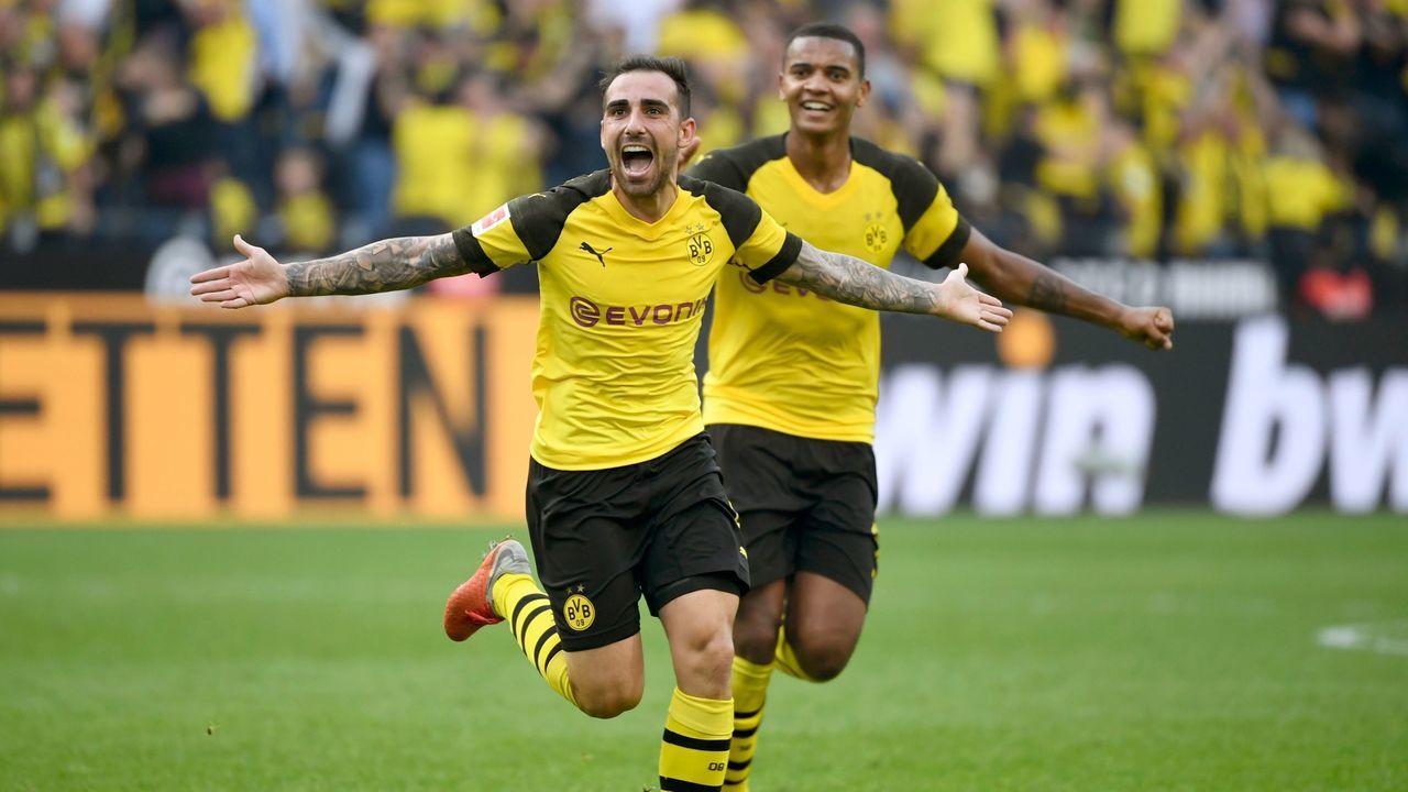 Dortmund's Spanish forward Paco Alcacer and Dortmund's French defender Abdou Diallo (R) celebrate scoring the 4-3 against Augsburg during the German first division Bundesliga football match Borussia Dortmund vs FC Augsburg in Dortmund, western Germany, on October 6, 2018.