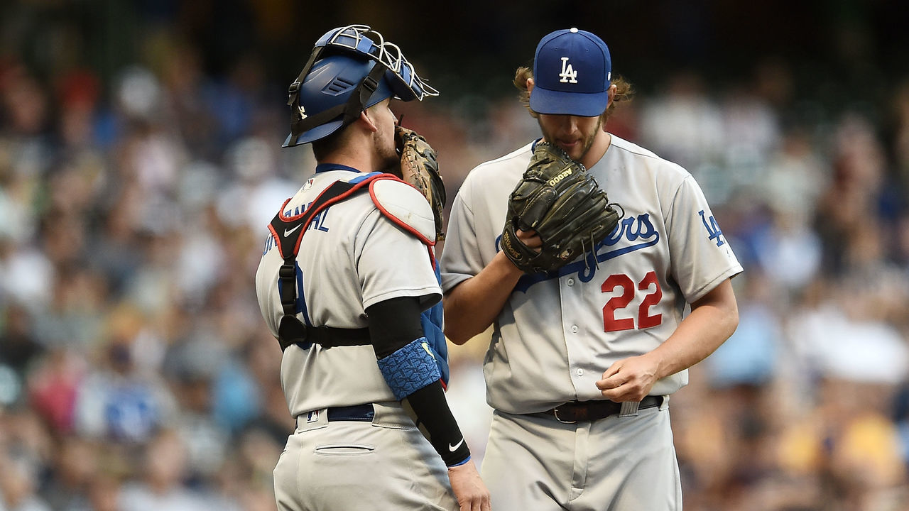 MILWAUKEE, WI - JUNE 02: Clayton Kershaw #22 of the Los Angeles Dodgers speaks with Yasmani Grandal #9 during the first inning of a game against the Milwaukee Brewers at Miller Park on June 2, 2017 in Milwaukee, Wisconsin.