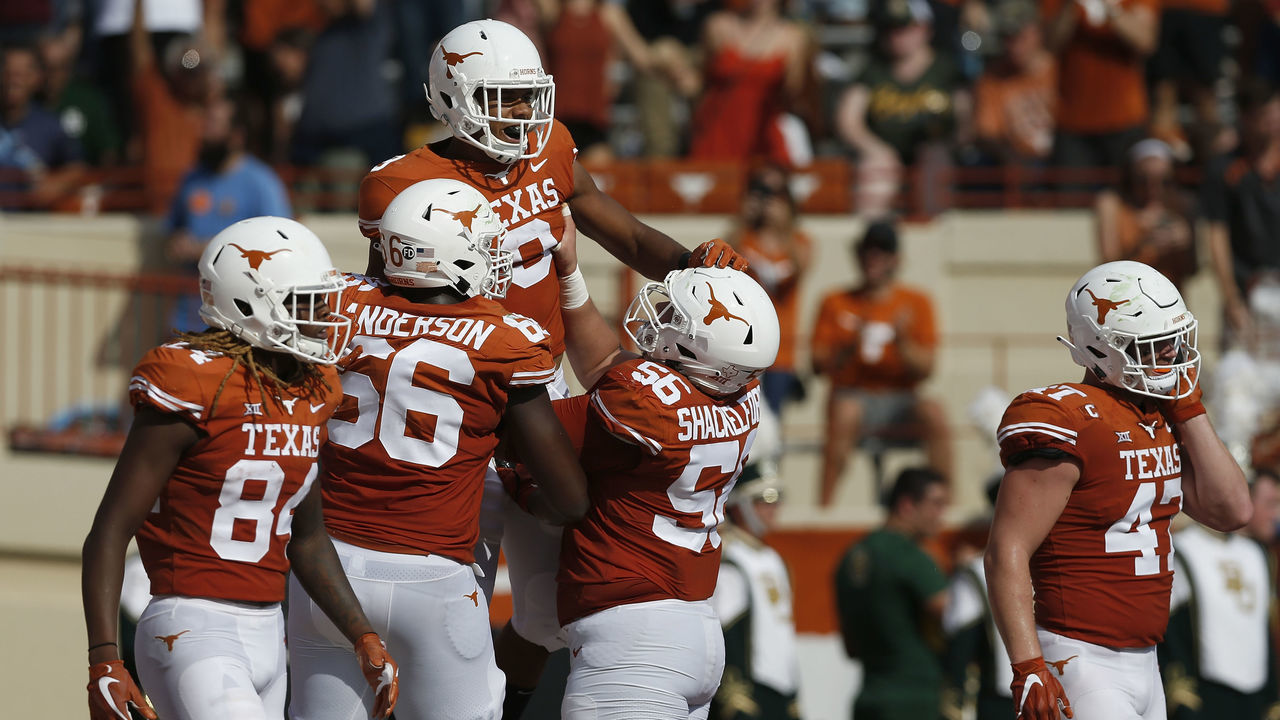 AUSTIN, TX - OCTOBER 13: Collin Johnson #9 of the Texas Longhorns is congratulated by teammates after a first half touchdown against the Baylor Bears at Darrell K Royal-Texas Memorial Stadium on October 13, 2018 in Austin, Texas.