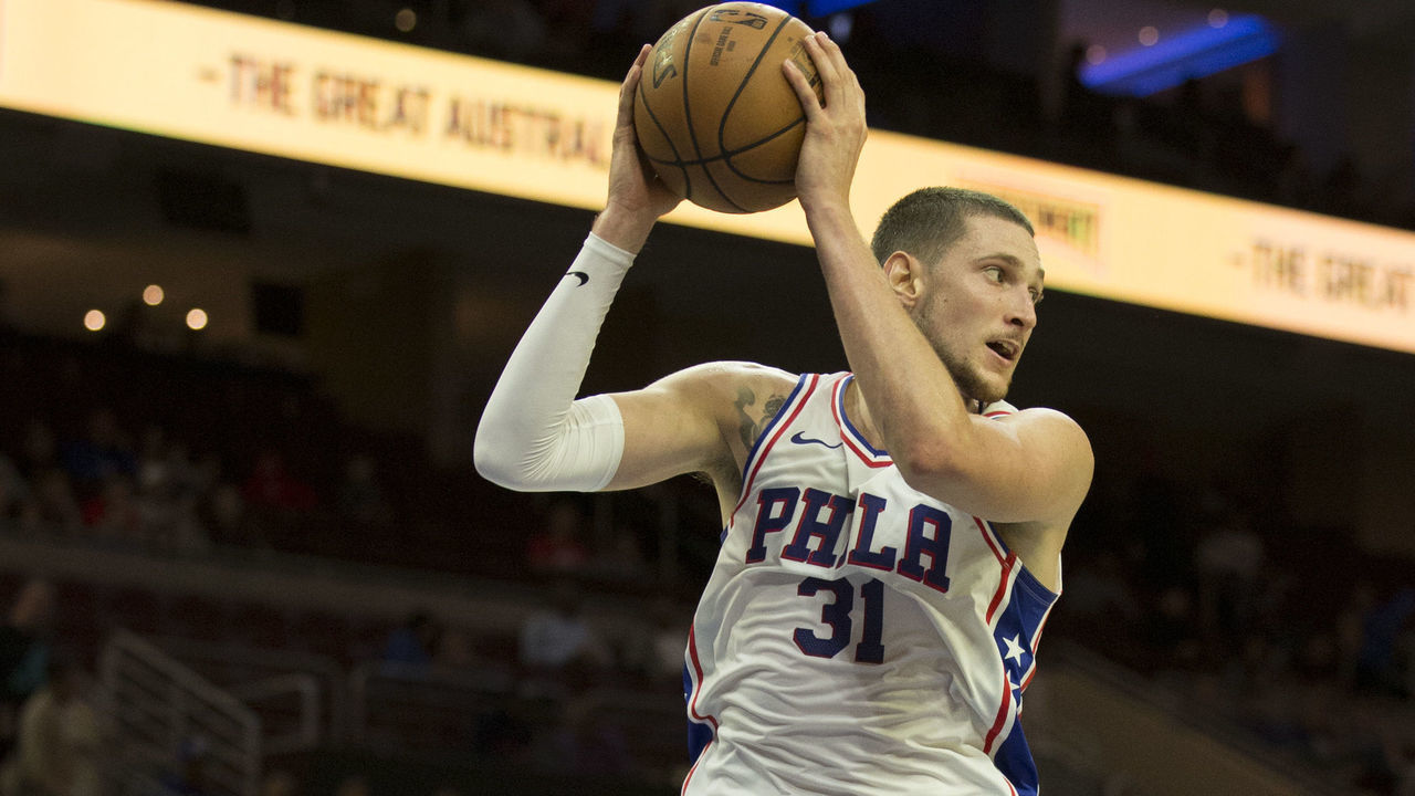 PHILADELPHIA, PA - SEPTEMBER 28: Mike Muscala #31 of the Philadelphia 76ers grabs a rebound against Melbourne United in the preseason game at Wells Fargo Center on September 28, 2018 in Philadelphia, Pennsylvania.