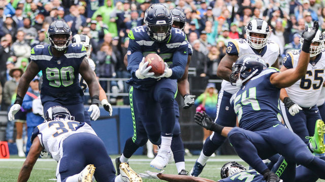 SEATTLE, WA - OCTOBER 07: Defense End Frank Clark #55 of the Seattle Seahawks intercepts the ball in the first half agains the Los Angeles Rams at CenturyLink Field on October 7, 2018 in Seattle, Washington.